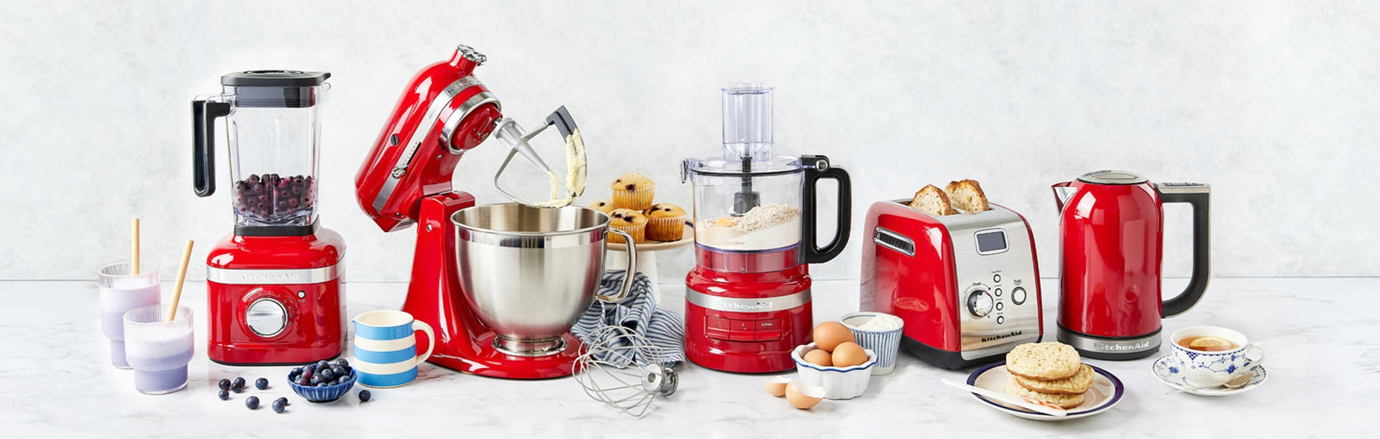 KitchenAid's iconic Empire Red collection featuring food processor, stand mixer, blender, toaster and kettle.